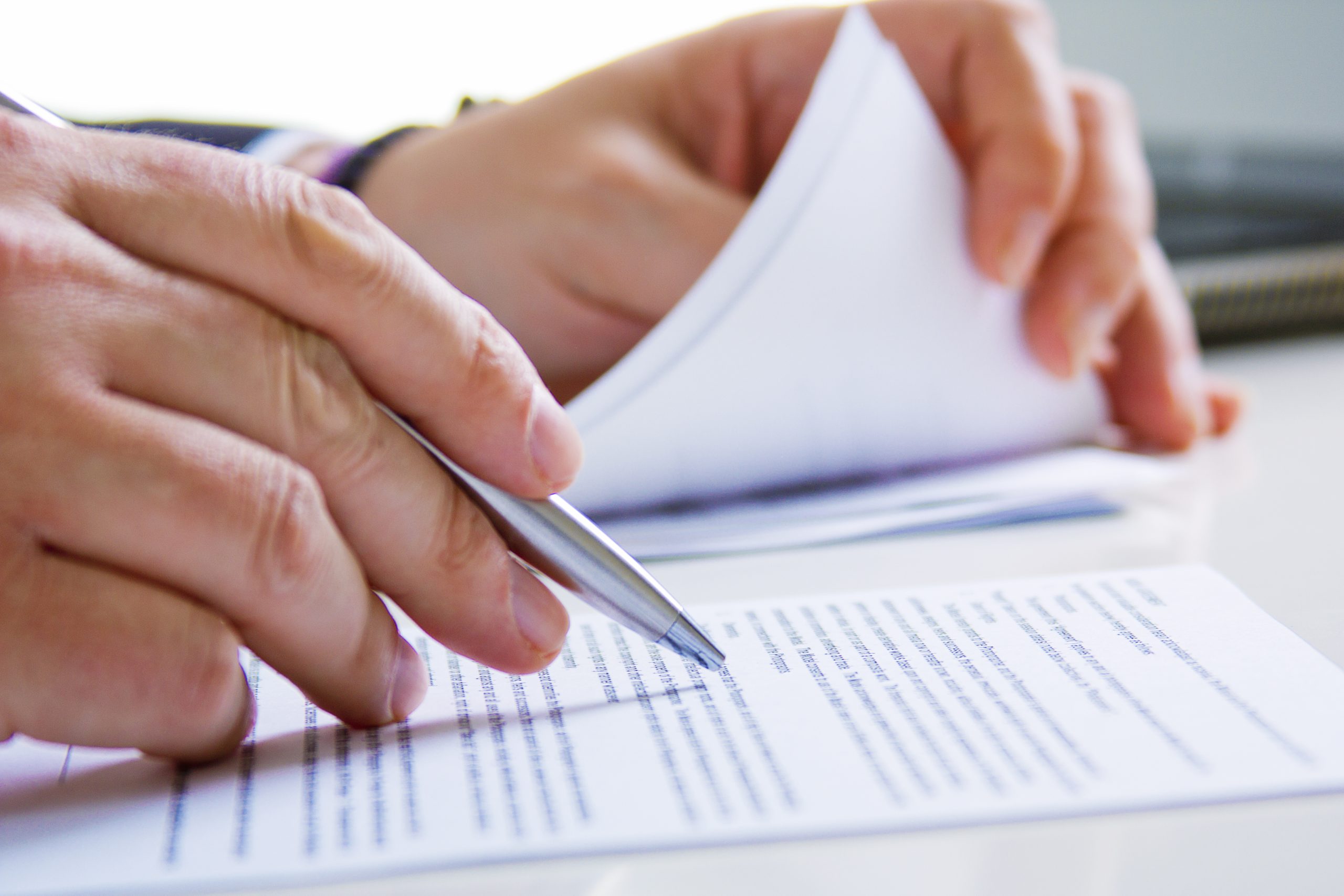Signing official surety bond paperwork for a Texas title or contractor bond at Calyco Surety Bonds & More.